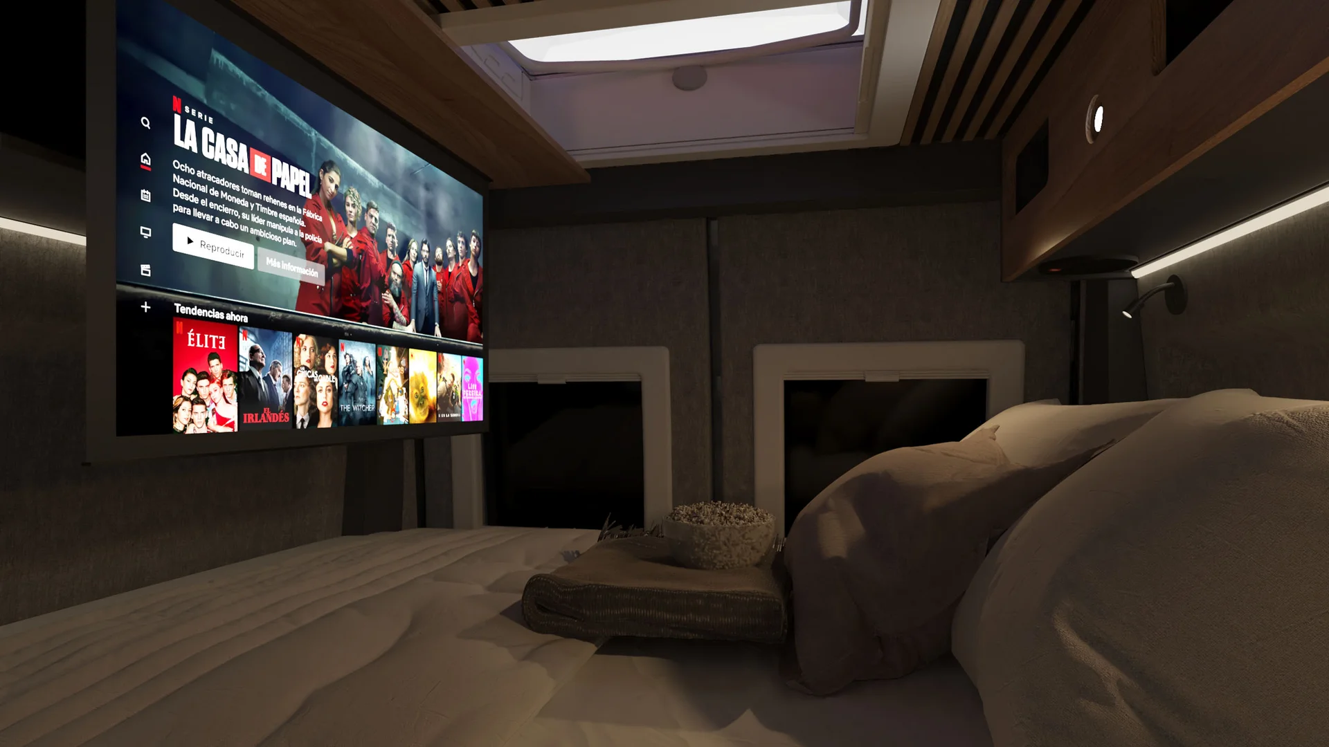 Interno di camper con letto e televisore con serie La Casa di Carta