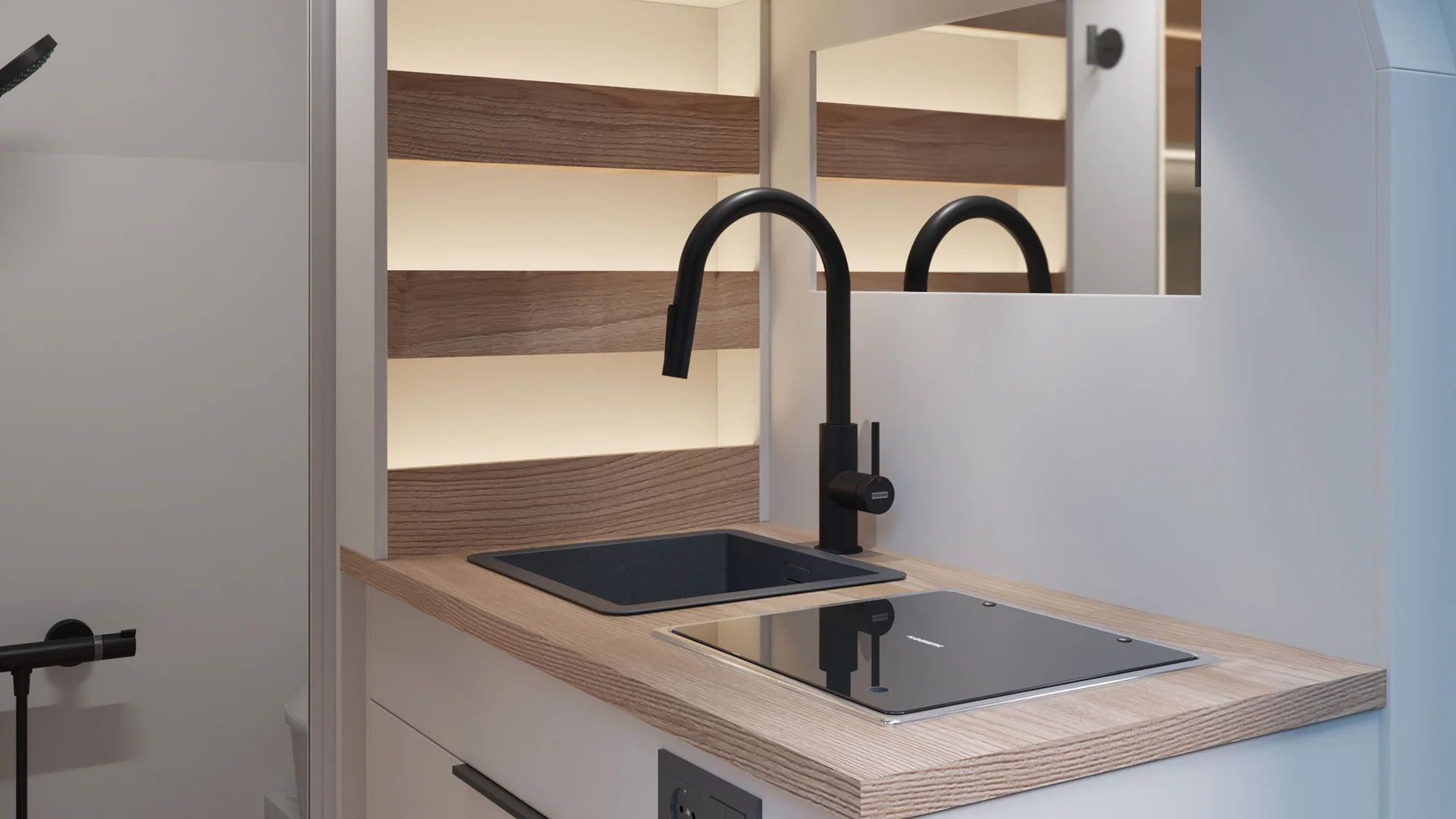 Cucina moderna compatta con lavandino nero e piano cottura